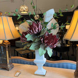 Custom Plum Protea Blossoms with Green and White Leaves in White Urn